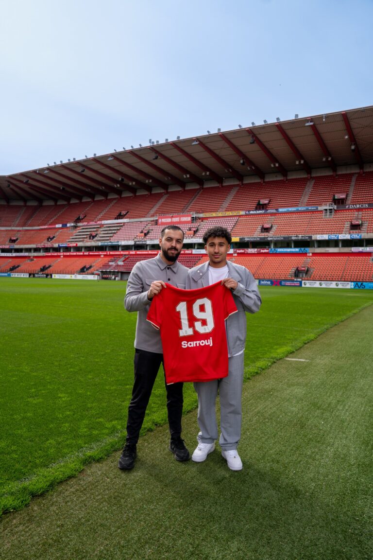 Yassine, fondateur de BeCreative, au stade du Standard de Liège avec un joueur et son maillot